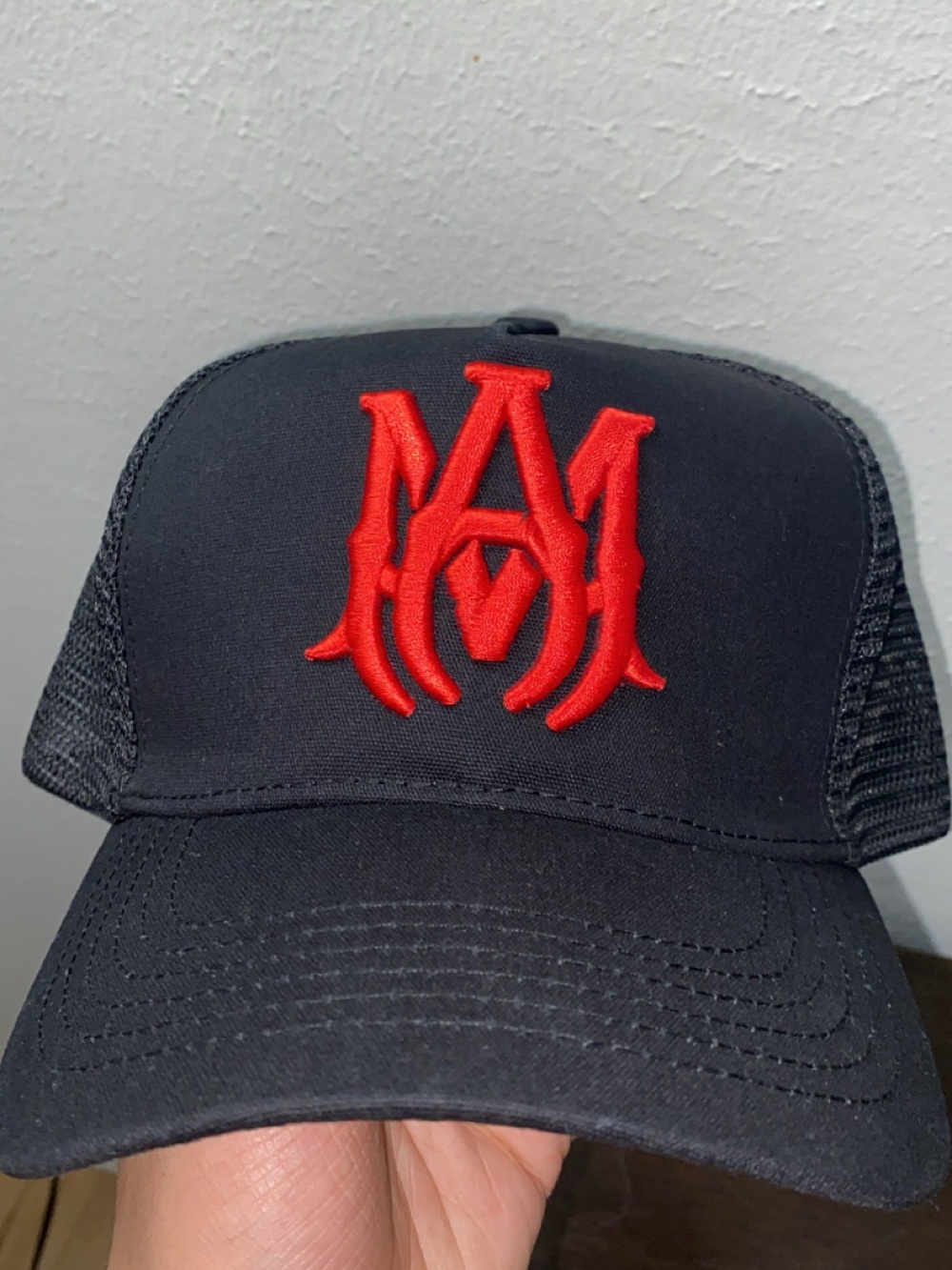Black Trucker Hat with Red Embroidered Logo